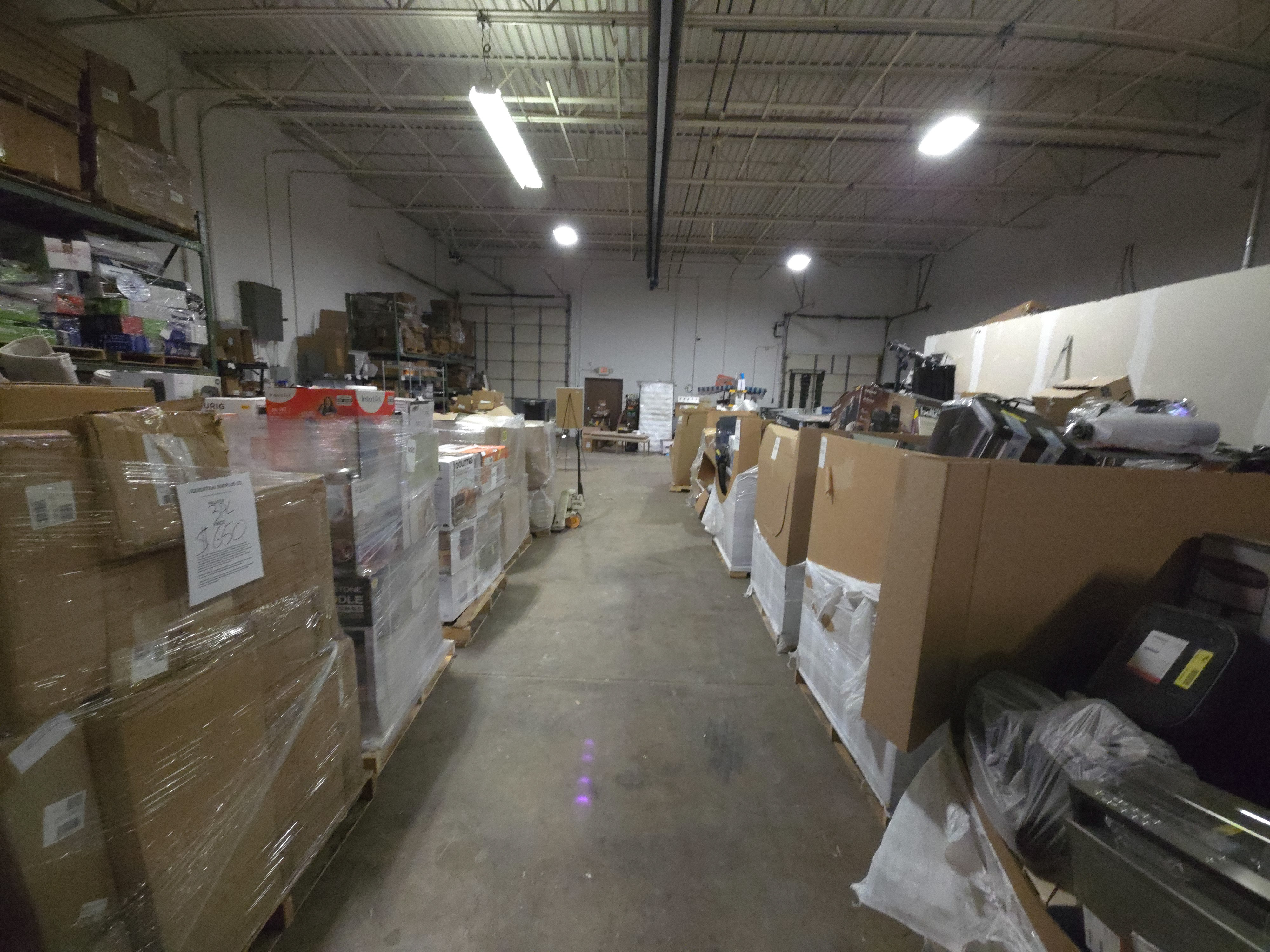 Wide view of the Liquidation Surplus Co. warehouse floor